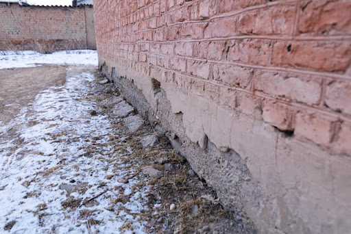 Water seeping into the foundation of a building as a result of flooding.